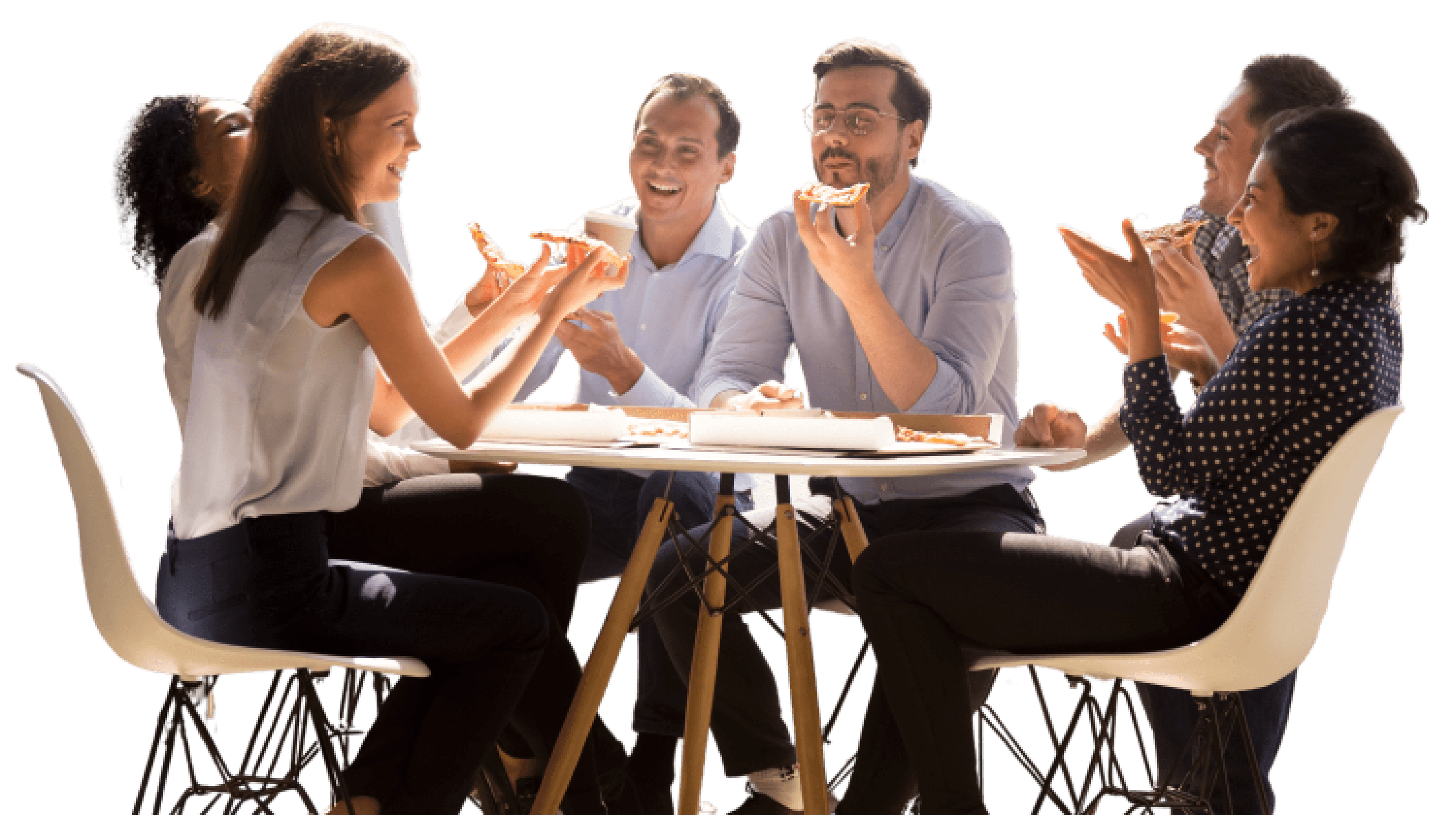 Group of people sitting around a table laughing and eating