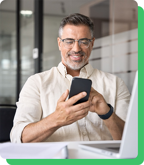 Image of man in glasses looking at his phone