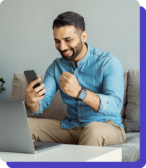 Image of a guy looking at his phone excited